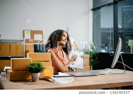 Woman Entrepreneur: SME Business mastering e-commerce with tablet, laptop, packaging, with Online Marketing, Packaging, Woman Entrepreneur: SME Business mastering e-commerce with tablet, laptop, packaging, with Online Marketing, Packaging, 130240337
