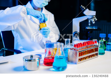 Biologist taking experiment with plants working in laboratory. 130240488