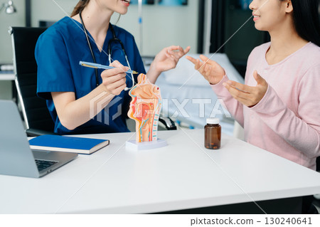 Doctor discussing treatment with Female patient talks to discuss results or symptoms and sitting on examination desk Doctor discussing treatment with Female patient talks to discuss results or symptoms and sitting on examination desk 130240641