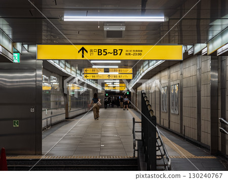 A guide sign for the ground-level exit installed in an underground passageway in the city center A guide sign for the ground-level exit installed in an underground passageway in the city center 130240767
