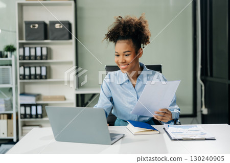 businesswoman working with working notepad, tablet and laptop documents talking on the smartphone, tablet businesswoman working with working notepad, tablet and laptop documents talking on the smartphone, tablet 130240905