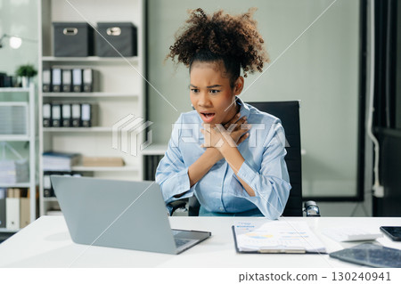 Woman feeling migraine head strain.Overworked businesswoman financier while working on laptop and tablet 130240941