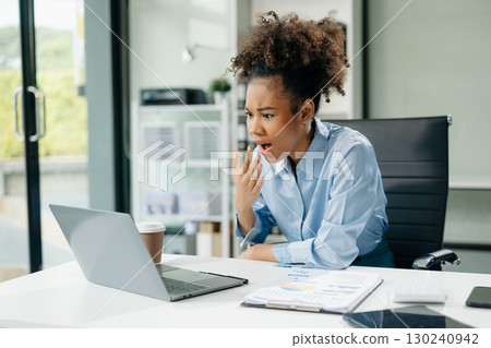 Woman feeling migraine head strain.Overworked businesswoman financier while working on laptop and tablet Woman feeling migraine head strain.Overworked businesswoman financier while working on laptop and tablet 130240942