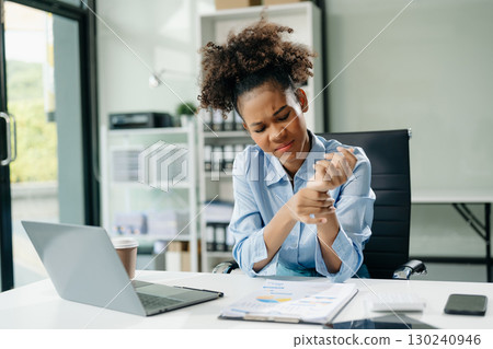 Overworked young Asian businesswoman office worker suffering from neck pain after had a long day at her office desk Overworked young Asian businesswoman office worker suffering from neck pain after had a long day at her office desk 130240946