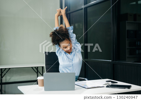 Overworked young Asian businesswoman office worker suffering from neck pain after had a long day 130240947