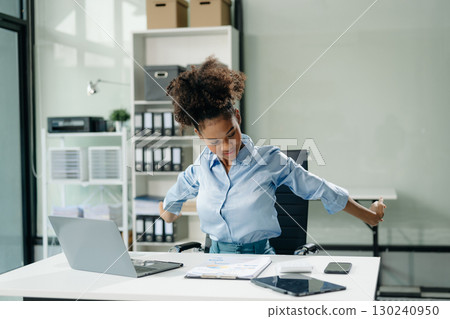 Overworked young Asian businesswoman office worker suffering from neck pain after had a long day Overworked young Asian businesswoman office worker suffering from neck pain after had a long day 130240950
