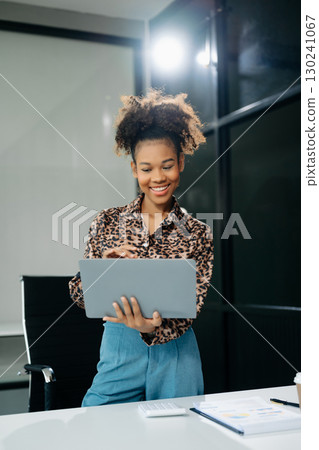 businesswoman working with working notepad, tablet and laptop documents talking on the smartphone, tablet businesswoman working with working notepad, tablet and laptop documents talking on the smartphone, tablet 130241067