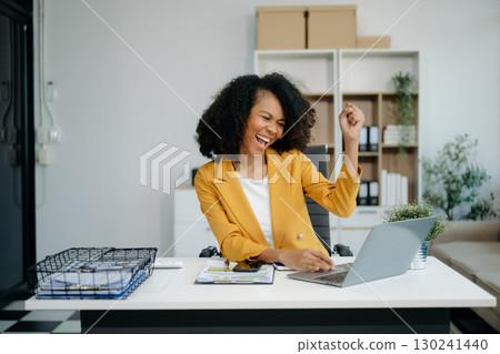 business woman are delighted and happy with the work they do on their tablet, laptop and taking notes at the office. 130241440