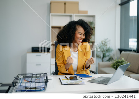 business woman are delighted and happy with the work they do on their tablet, laptop and taking notes at the office. 130241441