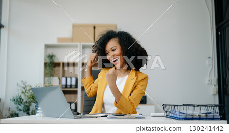 business woman are delighted and happy with the work they do on their tablet, laptop and taking notes at the office. 130241442