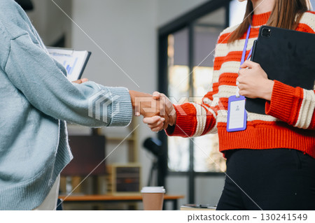 Two confident business man shaking hands during a meeting in the office, success, dealing, greeting and partner 130241549