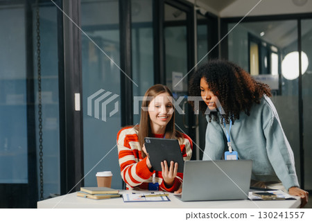Two business workers talking on the smartphone and using laptop Two business workers talking on the smartphone and using laptop 130241557