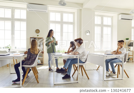 Teacher Conducting a Dynamic Classroom Lesson with Students 130241677