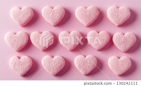 Heart shaped pink cookies arranged in delightful pattern, perfect for Valentine Day treats 130242111