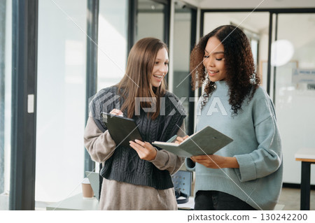 Asian business colleague business presents and explains and using laptop and tablet. Teamwork, financial marketing team 130242200