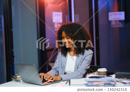 Woman feeling migraine head strain.Overworked businesswoman financier while working on laptop and tablet 130242318