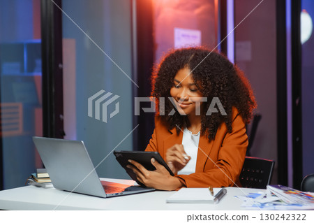 Woman feeling migraine head strain.Overworked businesswoman financier while working on laptop and tablet 130242322