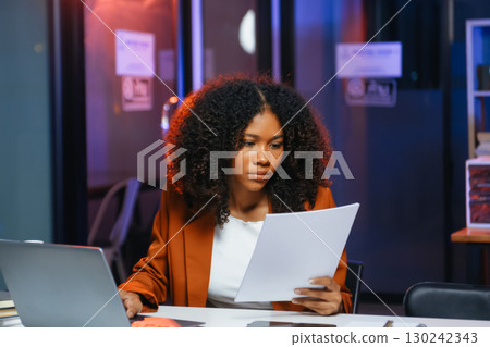 Woman feeling migraine head strain.Overworked businesswoman financier while working on laptop and tablet 130242343