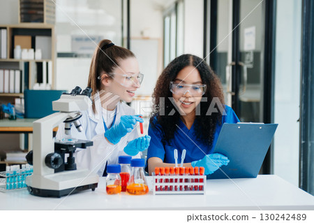 Scientist two woman with tablet and laptop, laboratory and ecofriendly science. Agriculture, research and scientists with online reading, test samples 130242489