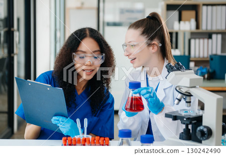 Scientist two woman with tablet and laptop, laboratory and ecofriendly science. Agriculture, research and scientists with online reading, test samples 130242490