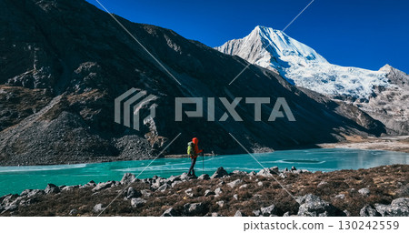 Backpacking woman hiking on high altitude mountains 130242559