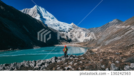 Backpacking woman hiking on high altitude mountains 130242563