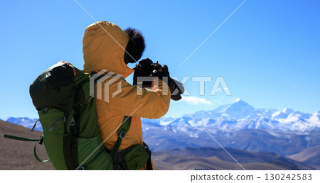 Successful woman photographer taking picture of Mount Everest in Tibet, China Successful woman photographer taking picture of Mount Everest in Tibet, China 130242583