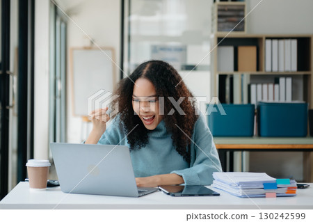 Asian businesswoman are delighted and happy with the work they do on their tablet, laptop and taking notes Asian businesswoman are delighted and happy with the work they do on their tablet, laptop and taking notes 130242599