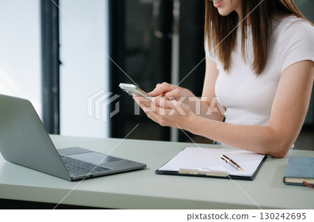 Businesswoman using mobile phone, tablet.Closeup on blurred background Businesswoman using mobile phone, tablet.Closeup on blurred background 130242695