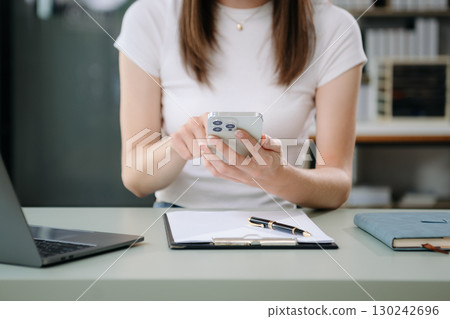 Businesswoman using mobile phone, tablet.Closeup on blurred background Businesswoman using mobile phone, tablet.Closeup on blurred background 130242696