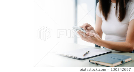 Businesswoman using mobile phone, tablet.Closeup on blurred background Businesswoman using mobile phone, tablet.Closeup on blurred background 130242697