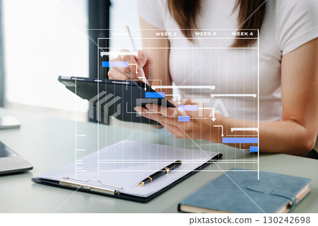 Project manager working and update tasks with milestones progress planning and Gantt chart scheduling diagram. 130242698