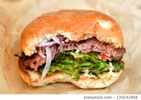 A delicious looking half-eaten hamburger A delicious looking half-eaten hamburger 130242908