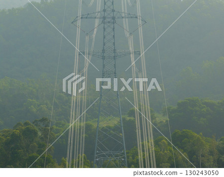 Aerial view of high voltage electricity tower on mountain 130243050