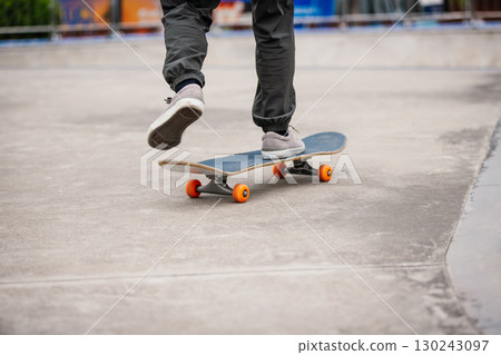 Skateboarder skateboarding at skatepark in city 130243097