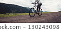 Riding mountain bike on mountain top 130243098