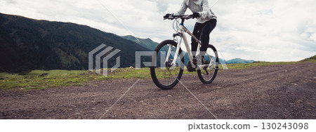 Riding mountain bike on mountain top Riding mountain bike on mountain top 130243098
