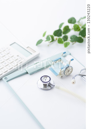 Stethoscope, binder and wheelchair Stethoscope, binder and wheelchair 130243220