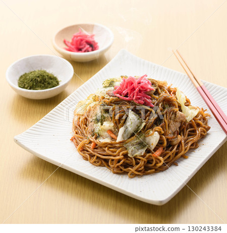 Freshly made piping hot yakisoba noodles with sauce, a classic home-cooked noodle dish garnished with pickled ginger and green laver. 130243384