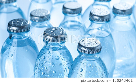 A scene of water bottles with caps lined up A scene of water bottles with caps lined up 130243401