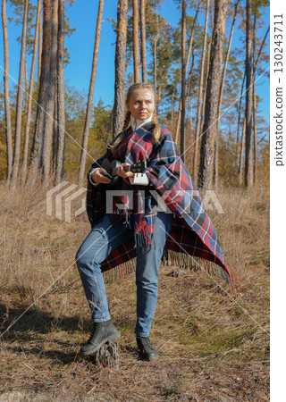 Portrait of smiling caucasian girl plays ukulele in autumnal park. Young woman plays guitar musical instrument outside in nature fall time. Audio music healing Portrait of smiling caucasian girl plays ukulele in autumnal park. Young woman plays guitar musical instrument outside in nature fall time. Audio music healing 130243711