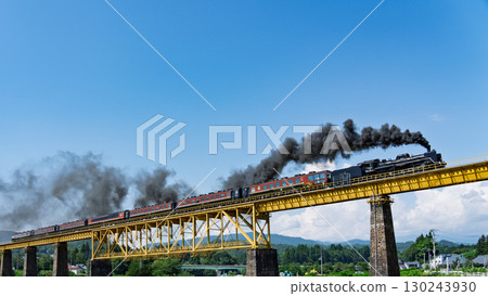 The steam locomotive and passenger car of the SL Banetsu Monogatari crossing the iron bridge 130243930