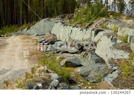 Beautiful and Scenic Quarry Landscape Featuring Lush Green Vegetation Alongside Rocky Terrain Beautiful and Scenic Quarry Landscape Featuring Lush Green Vegetation Alongside Rocky Terrain 130244267