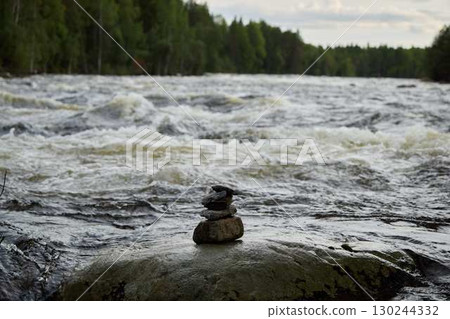A Beautiful Serene River Landscape Featuring a Collection of Balancing Stones Artistically Arranged A Beautiful Serene River Landscape Featuring a Collection of Balancing Stones Artistically Arranged 130244332