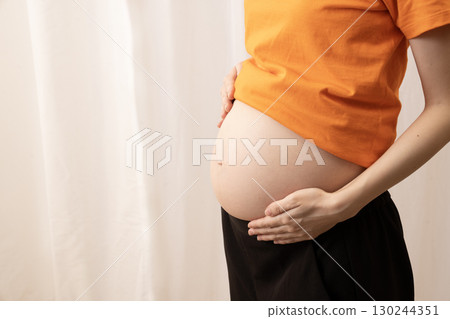 Women's stomach 8 months pregnant 130244351