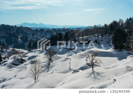 Snow-covered rice terraces and a clear blue sky 130244399