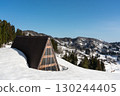 A snow-covered hut and rice terraces under a clear blue sky 130244405