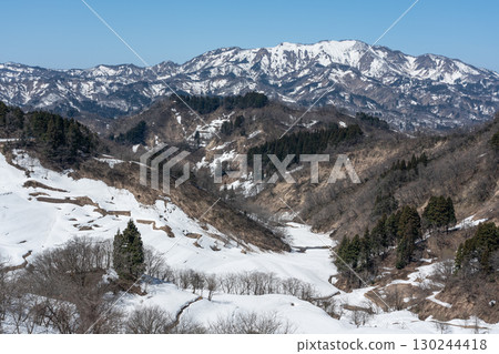 Snow-covered rice terraces and snow-capped mountains Snow-covered rice terraces and snow-capped mountains 130244418