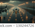 Lights and planes reflecting off a rain-soaked airport runway 130244726