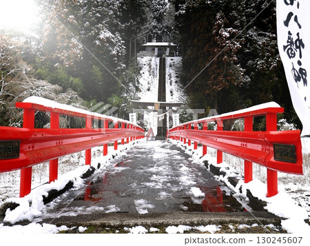 The red bridge to Tsubonuma Hachiman Shrine in winter 130245607